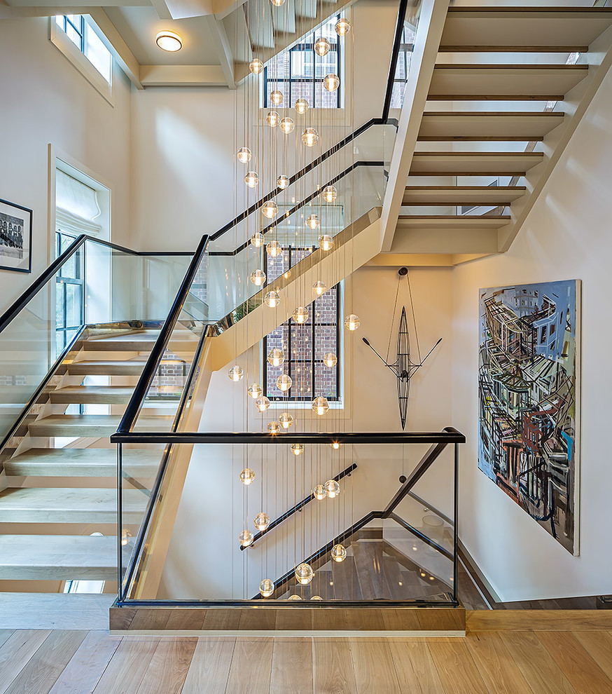 Classic wood u-shaped staircase in Toronto with open risers and feature lighting.
