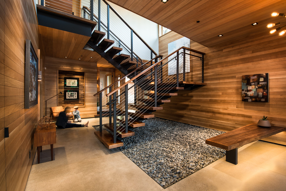 Large rustic wood floating staircase in Sacramento with open risers and feature lighting.