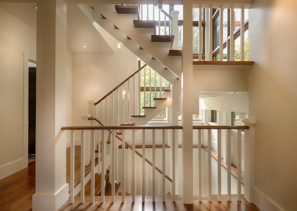 Staircase - large traditional wooden u-shaped wood railing staircase idea in Montreal with painted risers