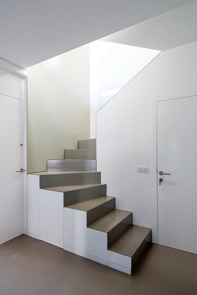 Идея дизайна: изогнутая металлическая лестница среднего размера в современном стиле с металлическими ступенями