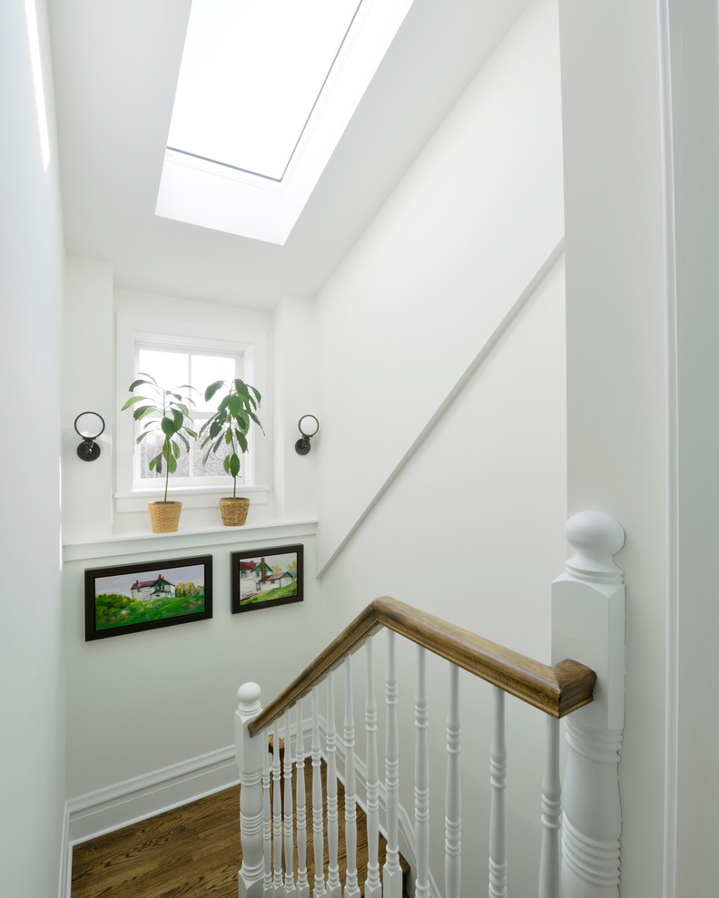 Transitional wooden u-shaped staircase photo in Ottawa with wooden risers