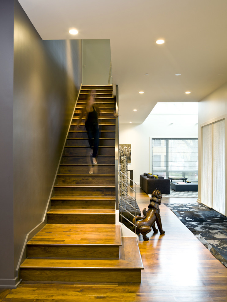 Design ideas for a contemporary wood straight staircase in Chicago with wood risers.
