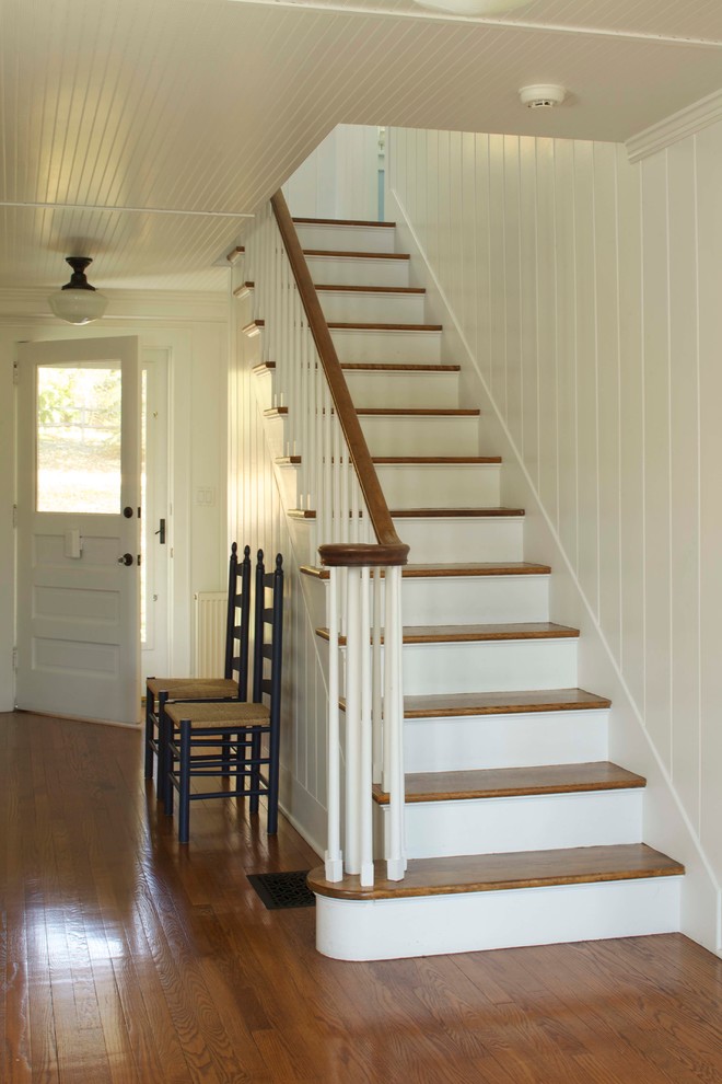 Inspiration for a medium sized classic wood straight staircase in New York with painted wood risers.