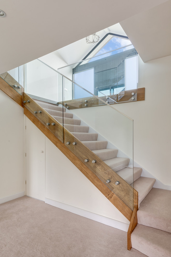 Design ideas for a contemporary carpeted straight staircase in Devon with carpeted risers.