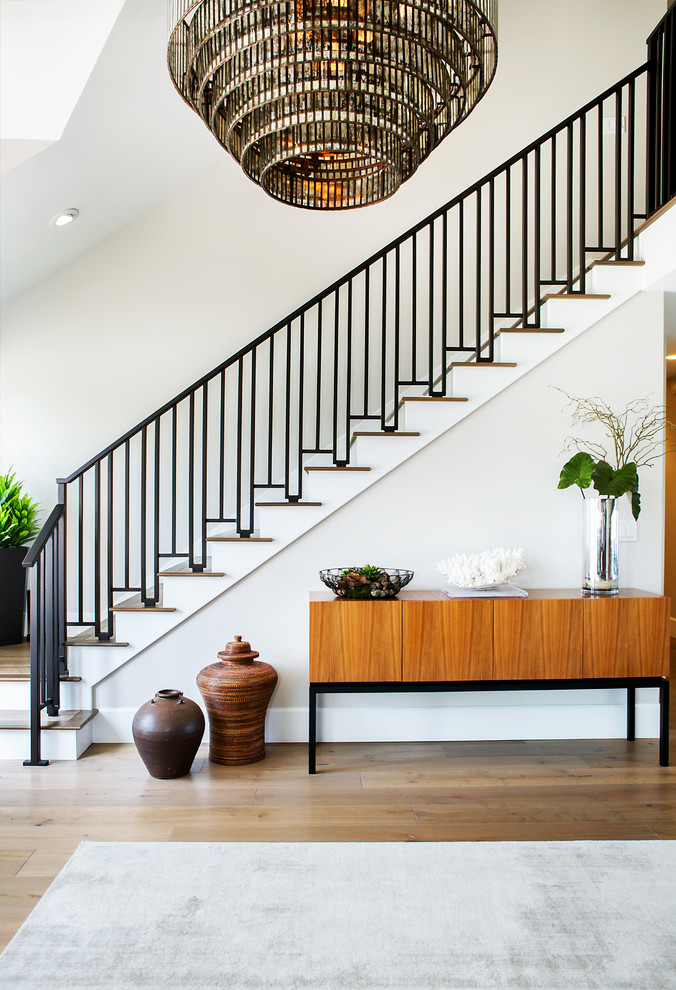 Medium sized contemporary wood l-shaped metal railing staircase in Orange County with painted wood risers.