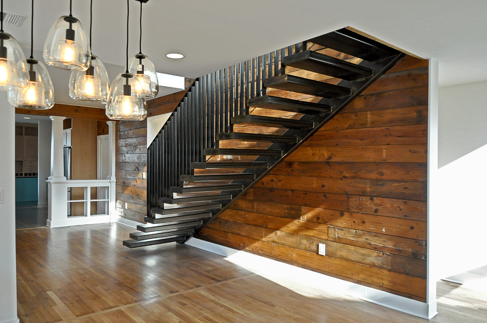 Photo of a large classic metal straight staircase in Austin with open risers.