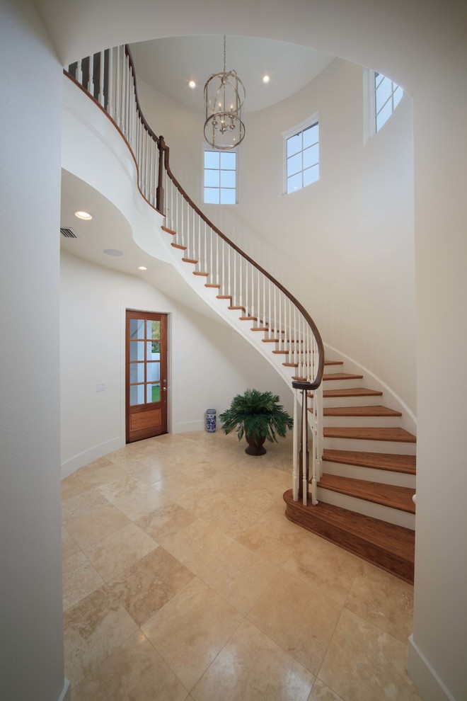 Inspiration for a transitional wooden curved staircase remodel in Orlando with painted risers