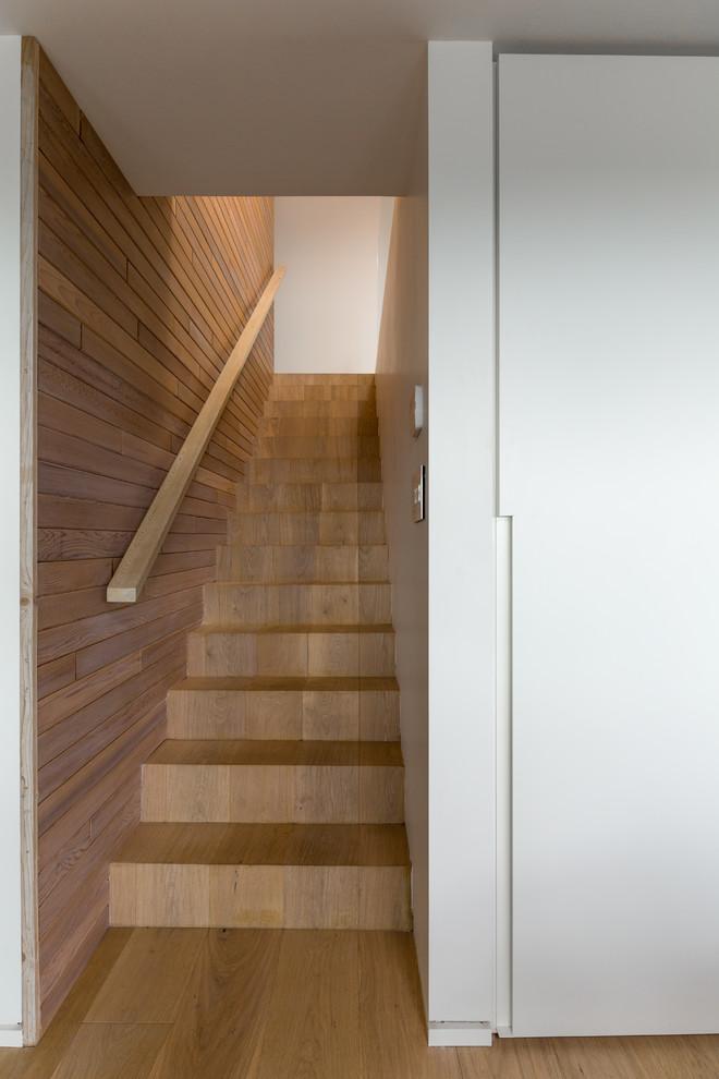 This is an example of a medium sized contemporary wood straight staircase.