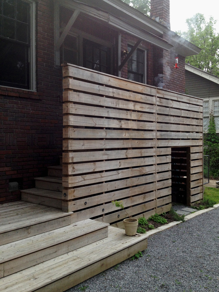 Inspiration for a small traditional wood l-shaped staircase in Other with wood risers.