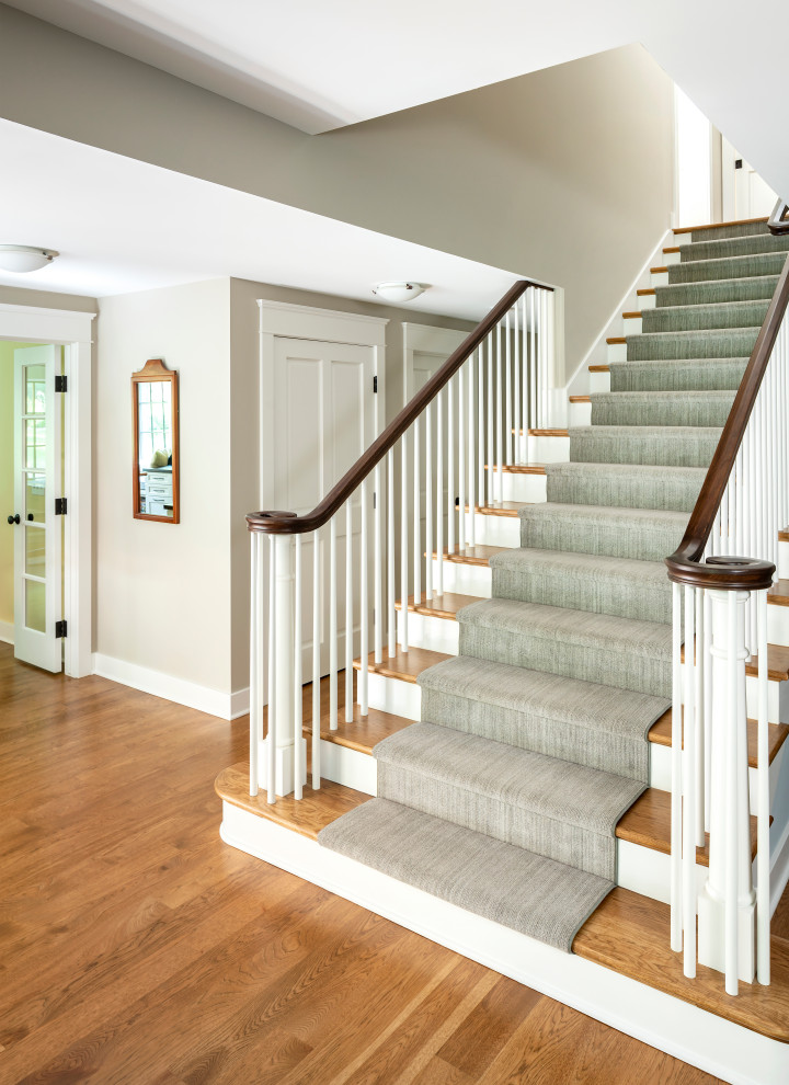 Example of a large classic wooden straight wood railing staircase design in Detroit with wooden risers