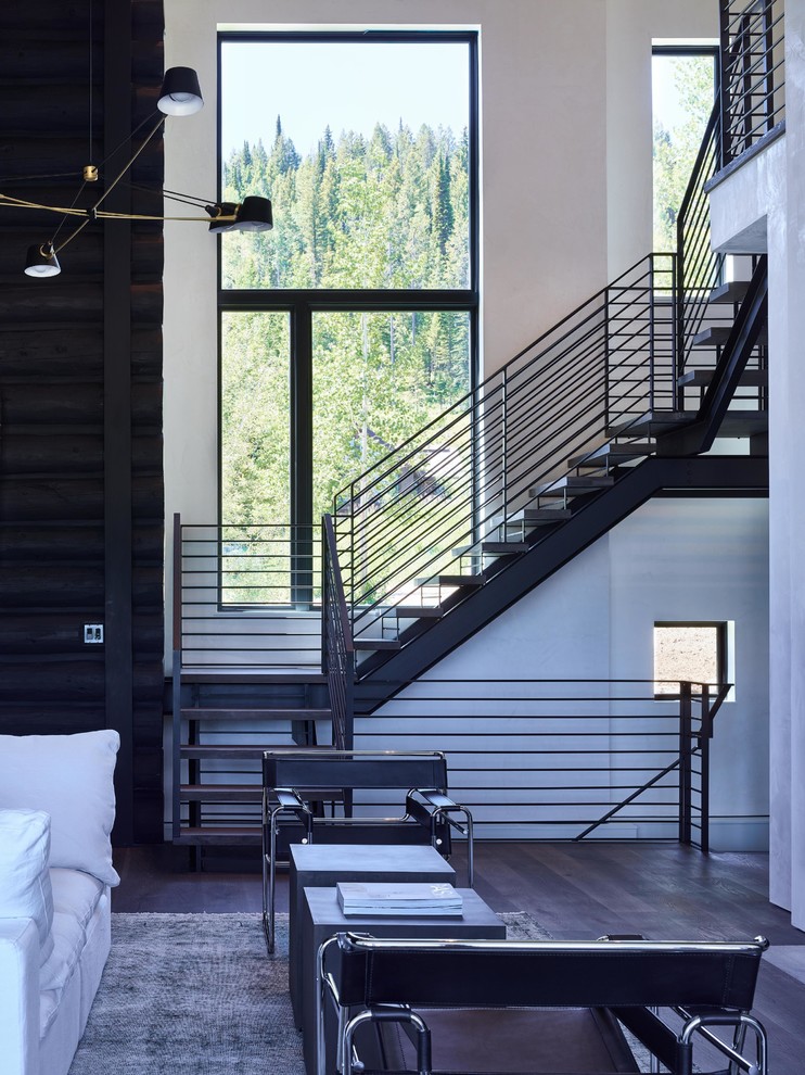 Example of a huge trendy wooden floating open and metal railing staircase design in Other