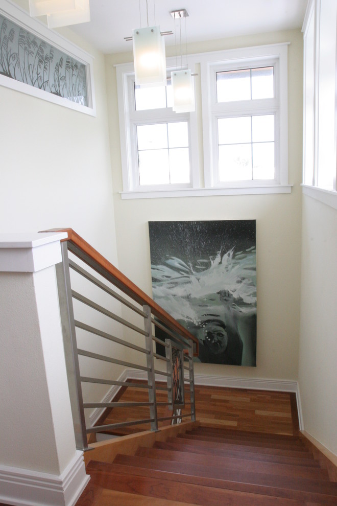 Photo of a medium sized nautical wood u-shaped staircase in Tampa with painted wood risers.