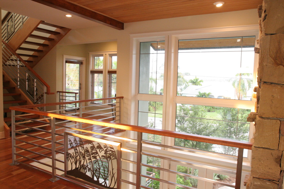 Inspiration for a medium sized beach style wood u-shaped staircase in Tampa with open risers.