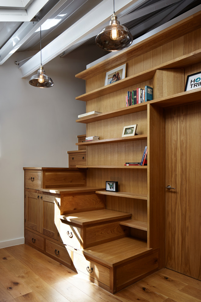 This is an example of a small industrial wood l-shaped staircase in London with wood risers.