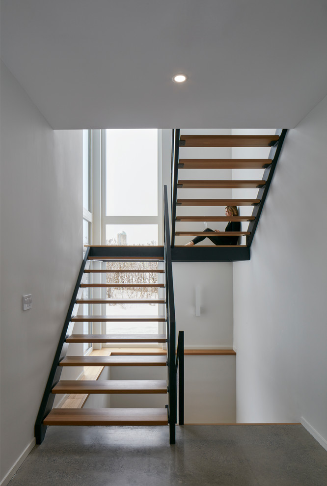 Inspiration for a large industrial wooden u-shaped open and metal railing staircase remodel in Ottawa