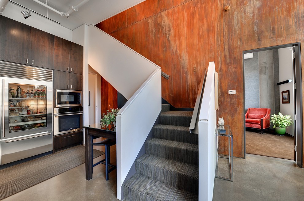 Urban carpeted l-shaped staircase photo in Minneapolis with carpeted risers