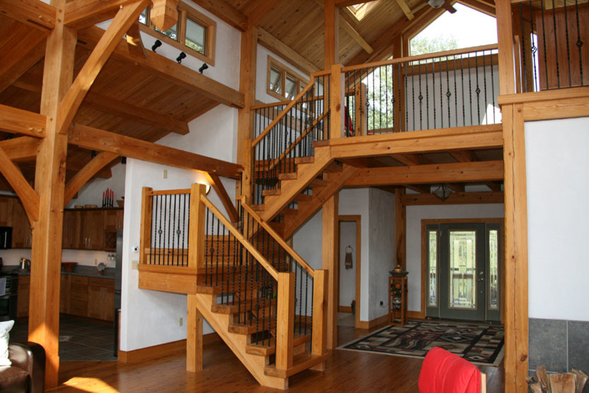 Photo of a medium sized rustic wood straight wood railing staircase in Other with open risers.