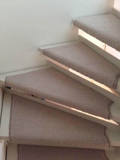 Medium sized classic carpeted floating metal railing staircase in London with carpeted risers.