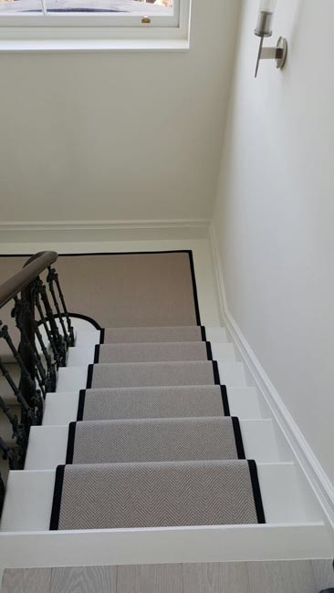 This is an example of a medium sized bohemian carpeted u-shaped staircase in London with carpeted risers.
