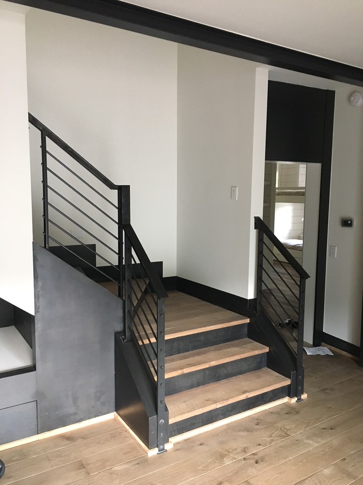 Inspiration for a mid-sized modern metal l-shaped mixed material railing staircase remodel in Columbus with metal risers