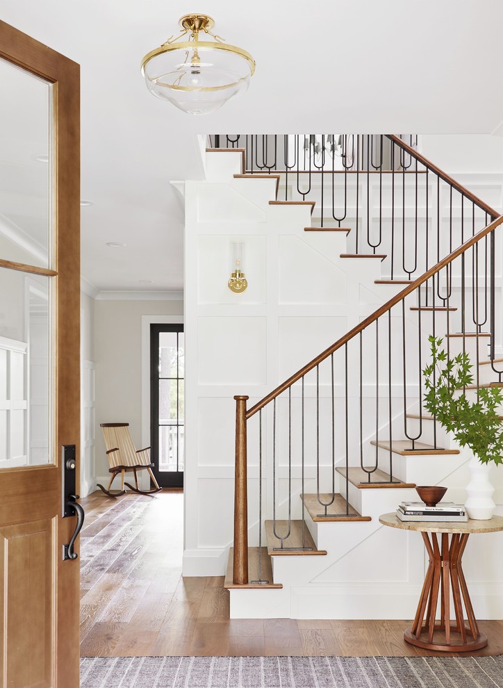 Inspiration for a transitional wooden u-shaped mixed material railing staircase remodel in Portland Maine with painted risers