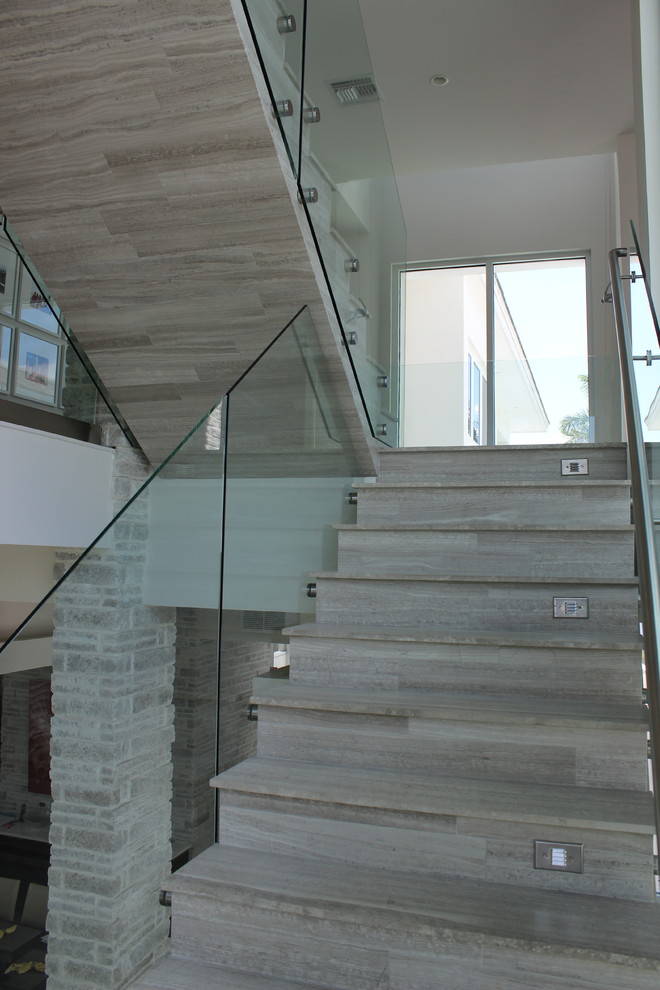 Photo of a medium sized contemporary tiled metal railing staircase in Other with tiled risers.