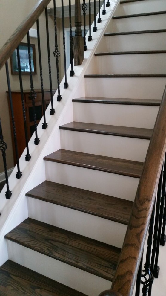 Medium sized classic wood straight staircase in Other with painted wood risers.