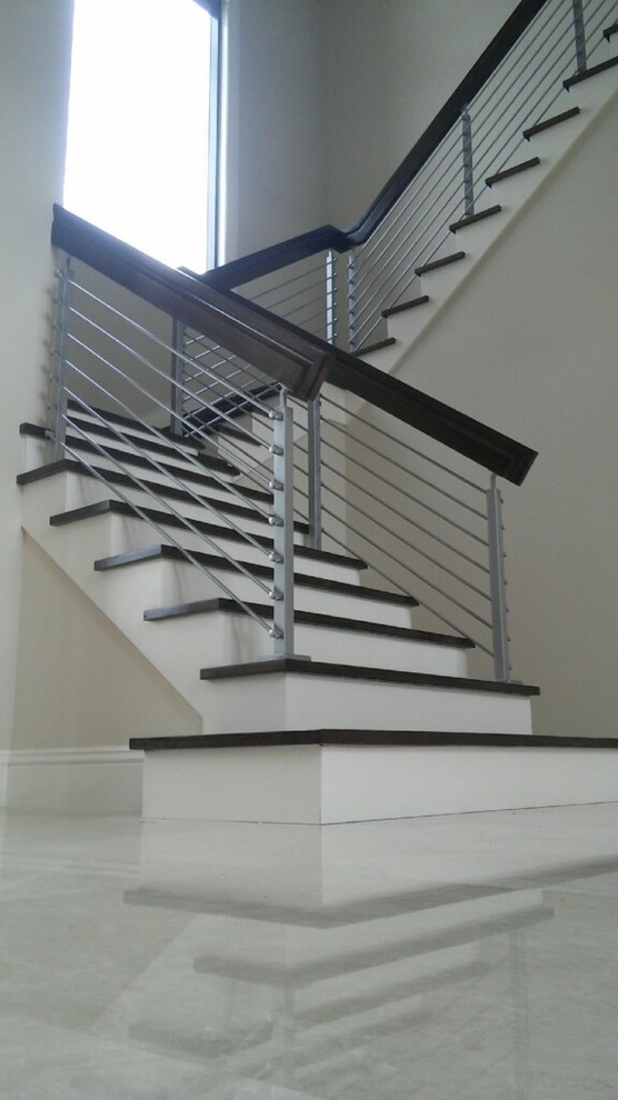 Photo of a small contemporary mixed railing staircase in Miami.