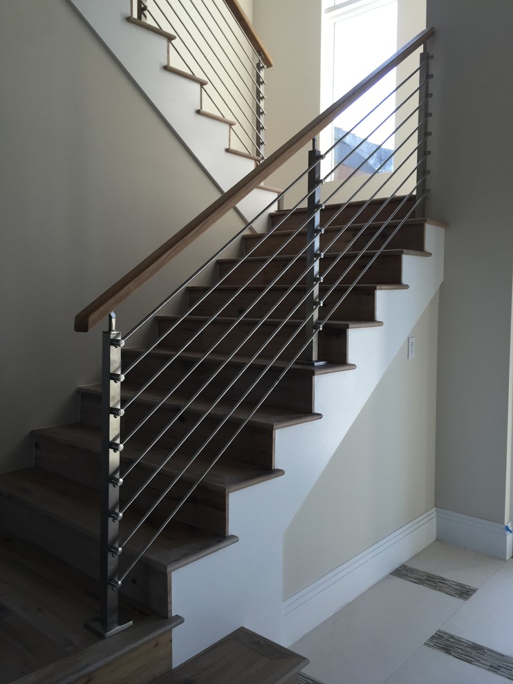 Small contemporary wood mixed railing staircase in Miami with wood risers.