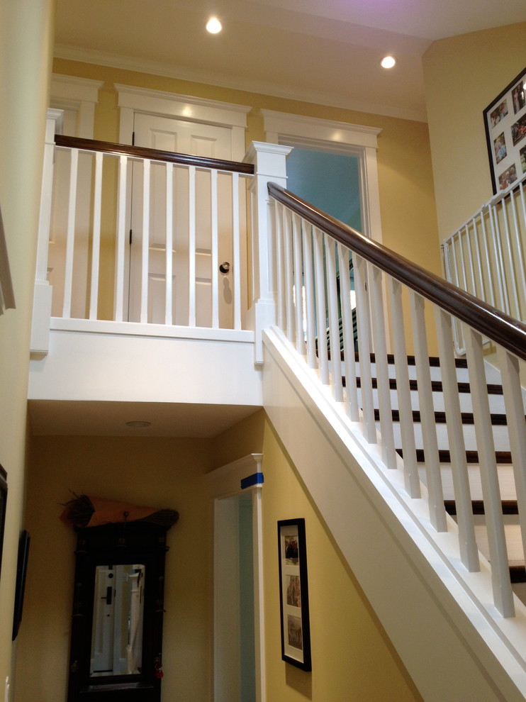 Inspiration for a mid-sized timeless wooden straight staircase remodel in San Francisco with painted risers