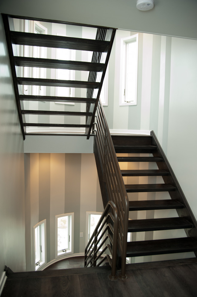 This is an example of a medium sized contemporary wood u-shaped staircase in New York with wood risers.