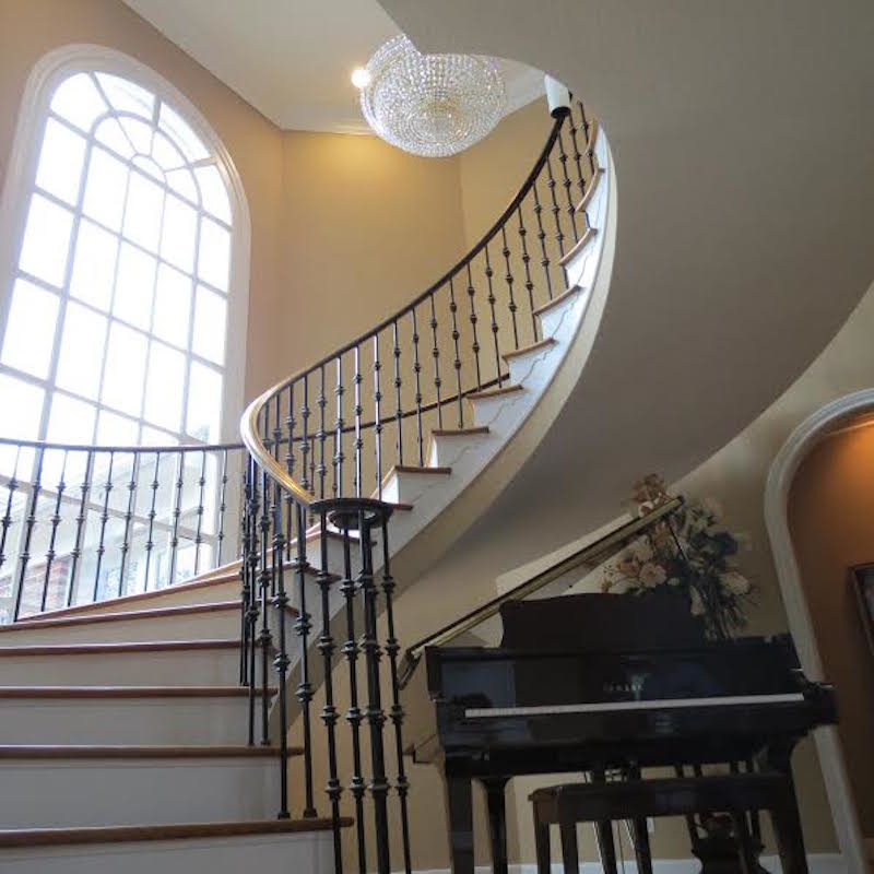 Photo of a contemporary wood curved staircase in Houston with painted wood risers.