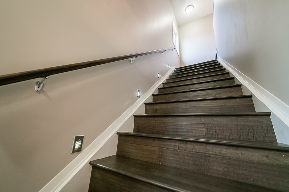 Photo of a medium sized contemporary painted wood straight staircase in Edmonton with wood risers and feature lighting.