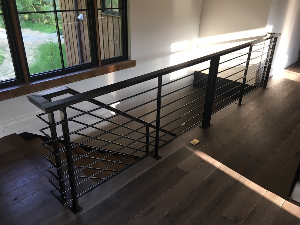 Design ideas for a large rustic wood straight metal railing staircase in Indianapolis with metal risers.