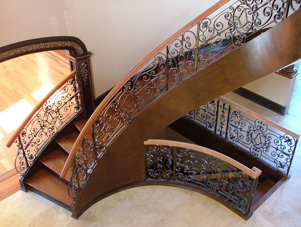 Example of a large classic wooden curved mixed material railing staircase design in New York with wooden risers