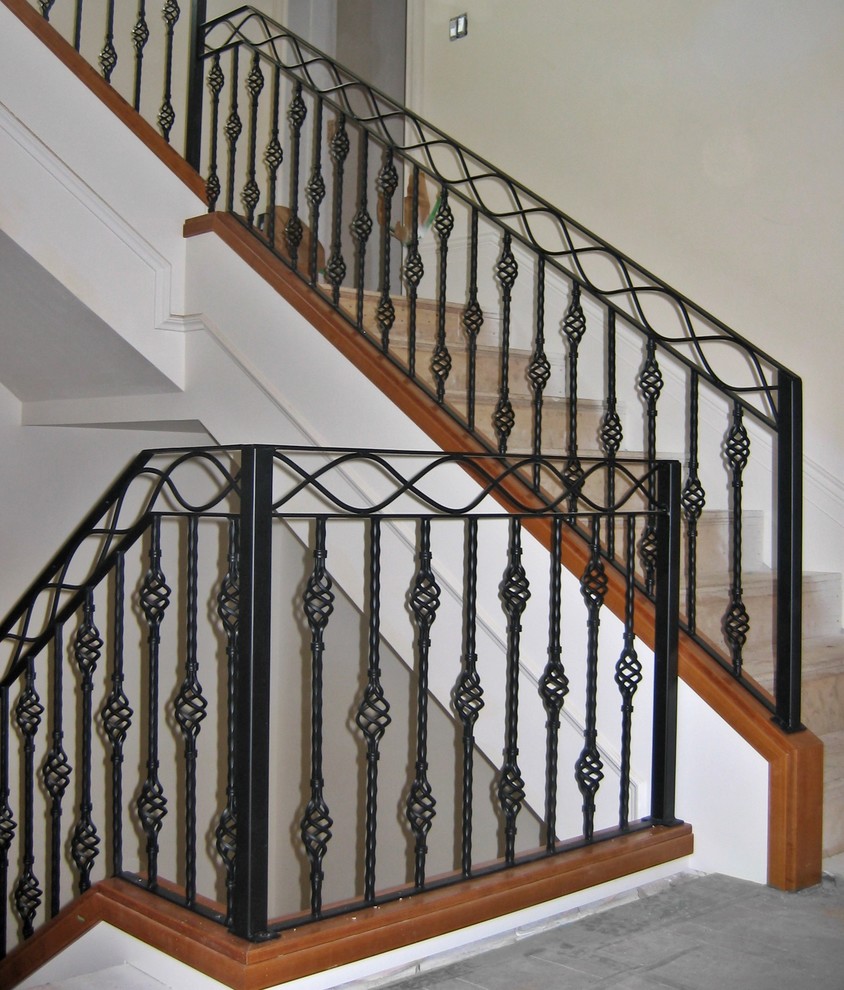 Mid-sized elegant carpeted u-shaped staircase photo in Vancouver with carpeted risers