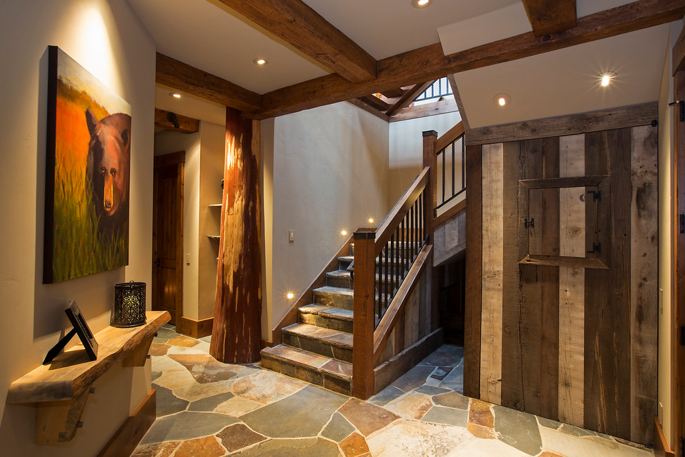 Example of a mountain style slate l-shaped mixed material railing staircase design in Other with slate risers