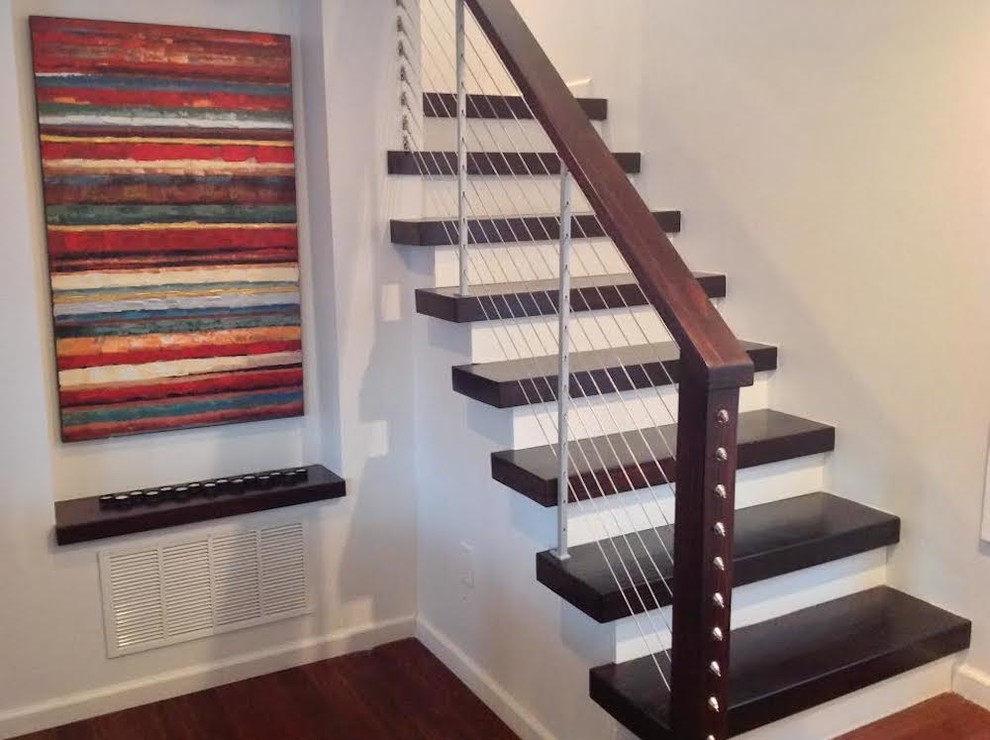 Wood l-shaped staircase in Philadelphia with painted wood risers.