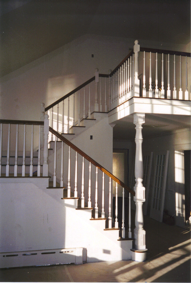Design ideas for a large traditional wood u-shaped staircase in Portland Maine with painted wood risers.
