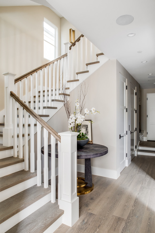 This is an example of a traditional staircase in Los Angeles with feature lighting.