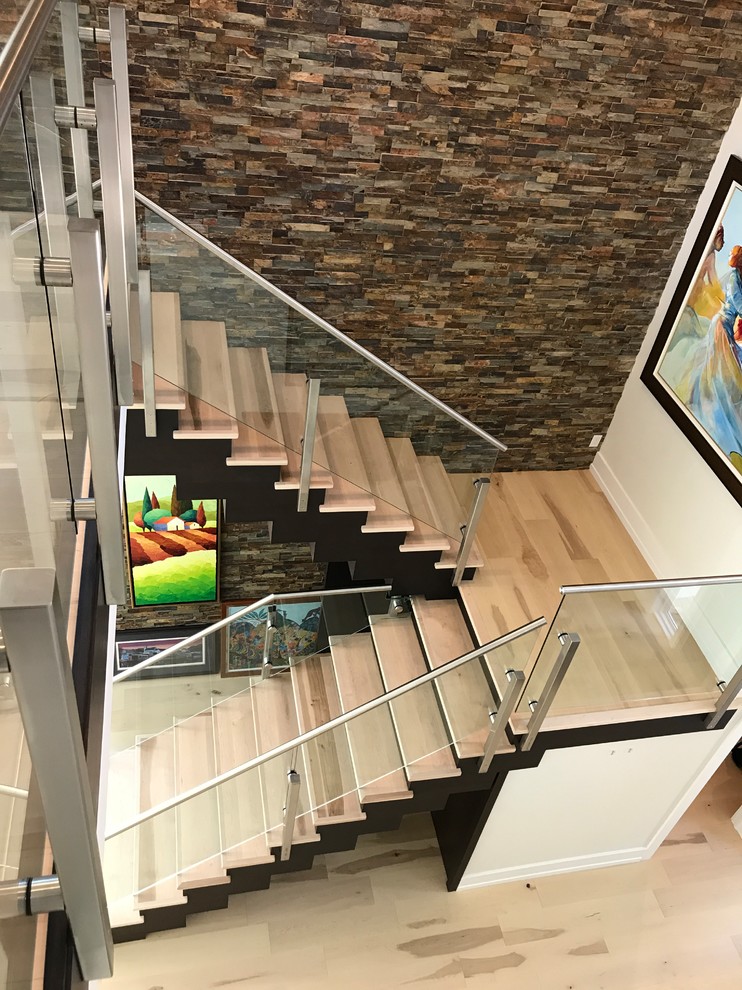Medium sized modern wood u-shaped glass railing staircase in Miami with painted wood risers.