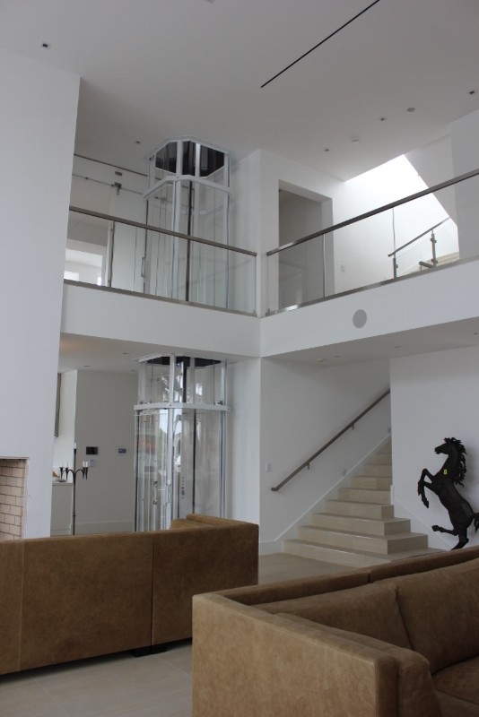 Пример оригинального дизайна: большая п-образная лестница в стиле модернизм с ступенями из плитки и подступенками из плитки