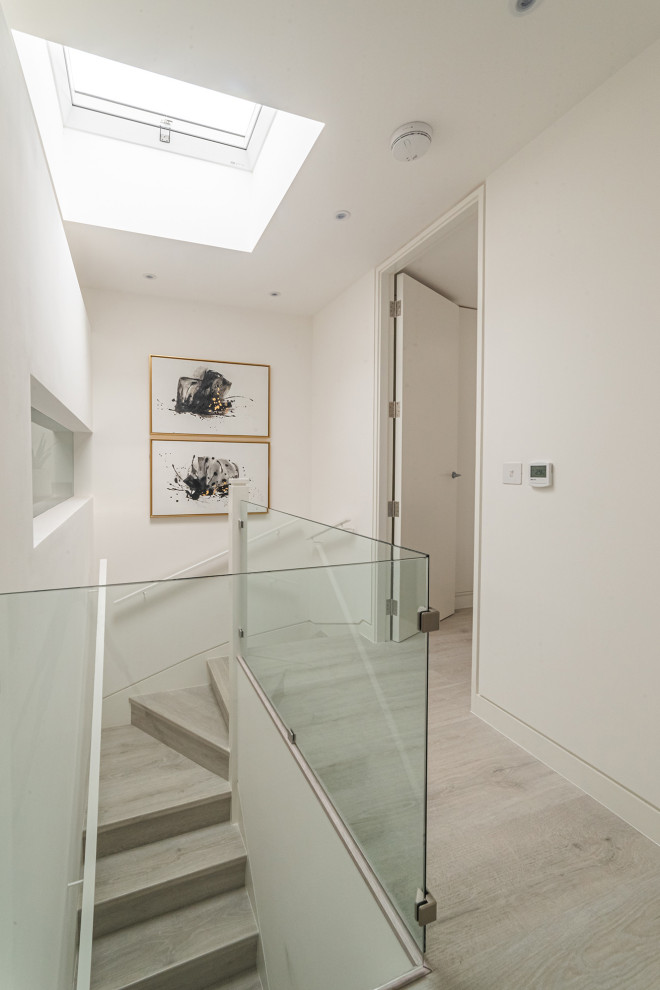 Inspiration for a mid-sized industrial hallway remodel in London with white walls