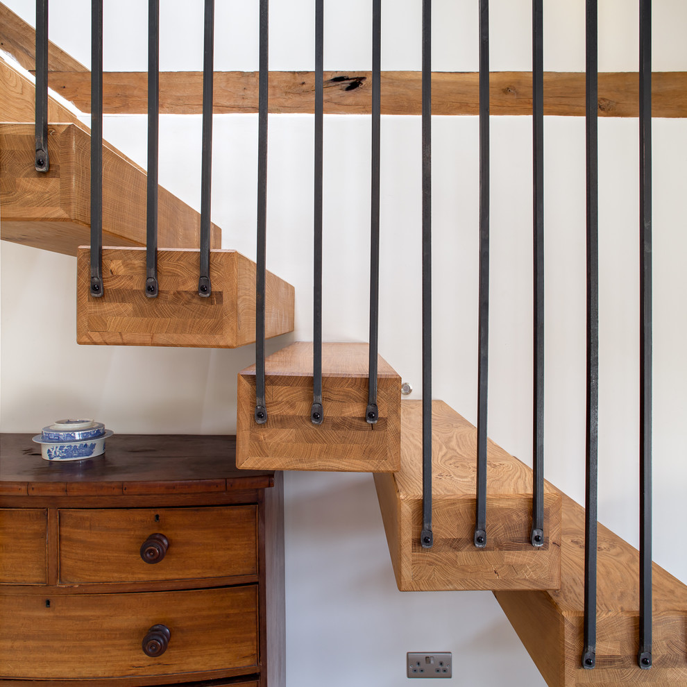 Inspiration for a mid-sized contemporary wooden floating staircase remodel in London with wooden risers