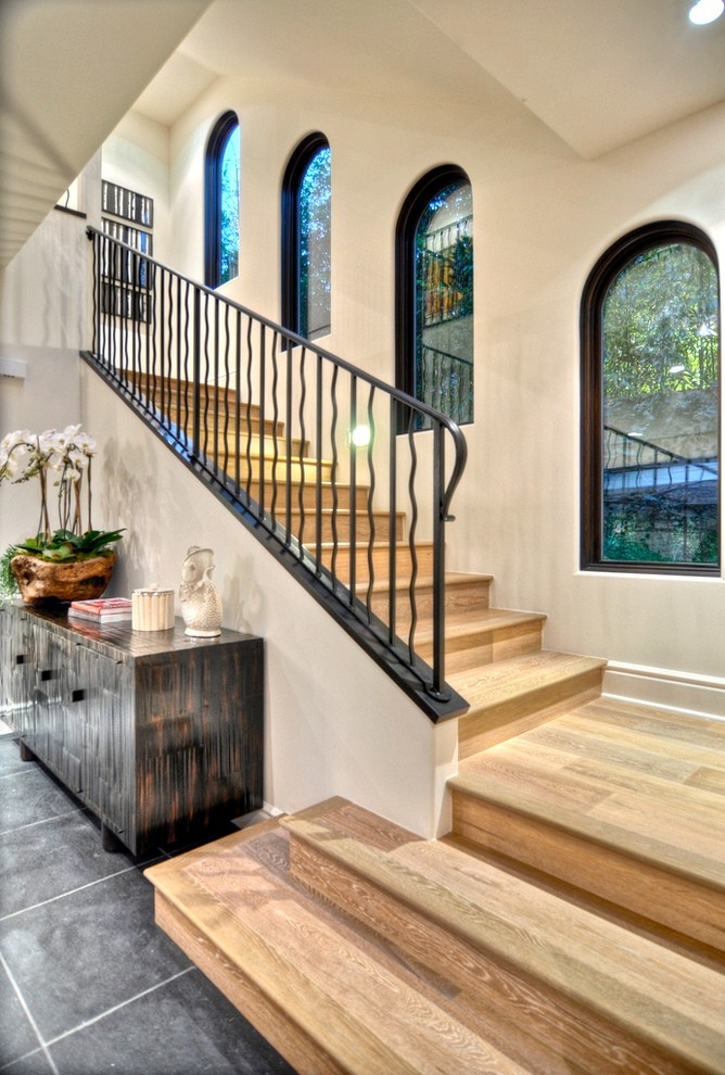 Inspiration for a mid-sized transitional wooden straight staircase remodel in Orange County with wooden risers