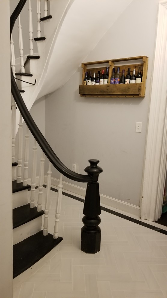 Mid-sized elegant painted spiral wood railing staircase photo in New York with painted risers