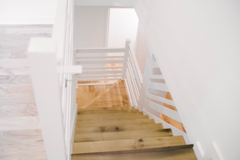 Idéer för mellanstora minimalistiska l-trappor i trä, med sättsteg i målat trä