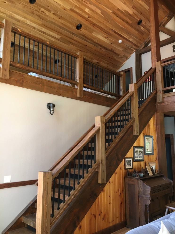 This is an example of a medium sized rustic wood straight staircase in Minneapolis with open risers.