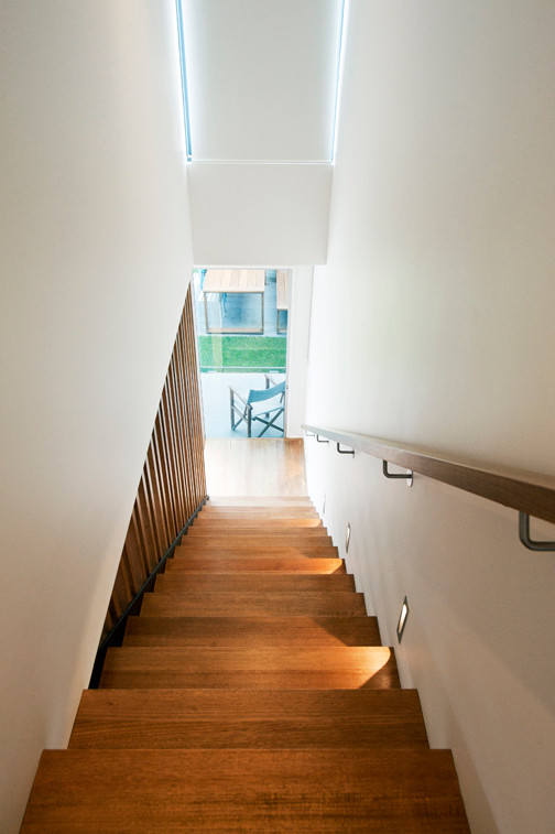 Example of a mid-sized trendy wooden straight open staircase design in Melbourne