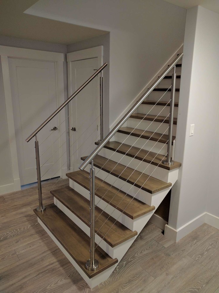 Design ideas for a medium sized modern wood straight wire cable railing staircase in Other with wood risers.